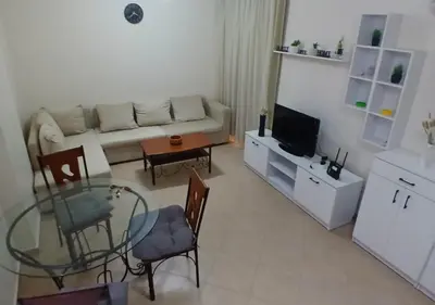 a living room with a couch and a glass table at Modern Apartment in the Britsh Resort in Hurghada