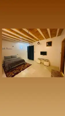 a large room with a bed and a couch at In Luxor in Luxor