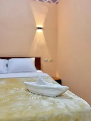a white towel sitting on top of a bed at Aswan City Center Hotel in Aswan