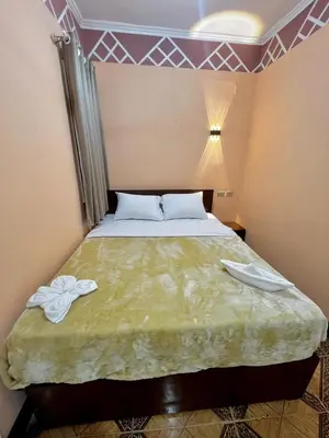 a bedroom with a bed with two towels on it at Aswan City Center Hotel in Aswan