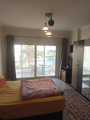 a bedroom with a bed and a view of a patio at Sky Star Villa 97 in Hurghada