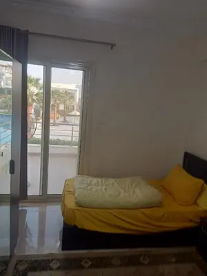 a bed in a room with a large window at Sky Star Villa 97 in Hurghada