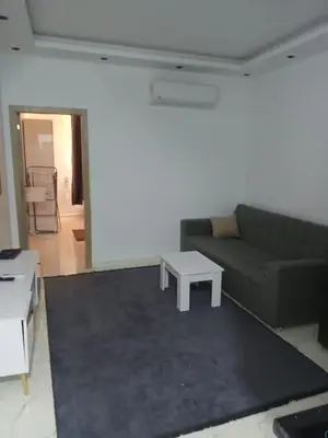 a living room with a couch and a table at Luona House in ‘Ezbet Abu Ḥabashi