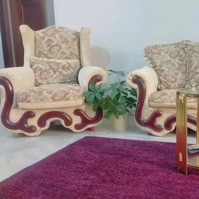 a living room with two chairs and a purple rug at happy apartment in Luxor
