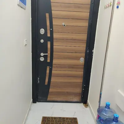 a wooden door with a mat in front of it at Appartement 2 slaapkamers in Hurghada