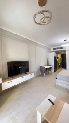 a living room with a large flat screen tv at Luxury apartment pool view in Hurghada