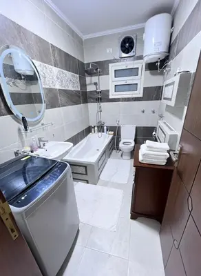 a bathroom with a sink and a toilet and a mirror at Hobby live in Hurghada in Hurghada