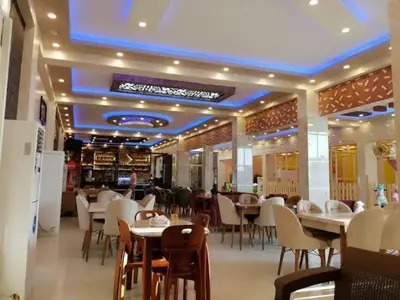 a dining room with tables and chairs in a restaurant at Hobby live in Hurghada in Hurghada
