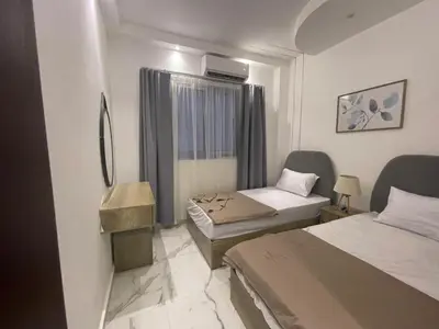 a hotel room with two beds and a window at اوسيس مارينا in Hurghada
