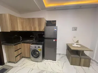 a kitchen with a refrigerator and a washing machine at اوسيس مارينا in Hurghada