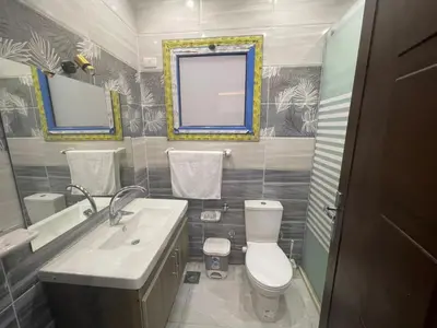 a bathroom with a toilet and a sink and a mirror at اوسيس مارينا in Hurghada