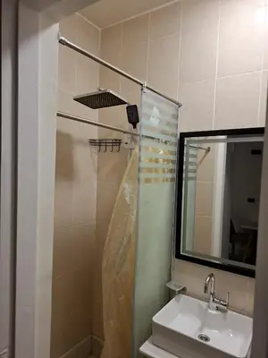 a bathroom with a shower and a sink and a mirror at Cozy flat in Makadi Heights in Hurghada
