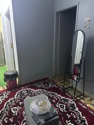 a room with a table and a mirror and a rug at أسوان in Aswan