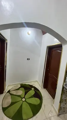 a room with a green circle on the floor next to a door at Sheba Kato in Jazīrat Aswān