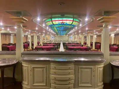 a dining room with pink tables and a stained glass ceiling at nile crouse in Luxor