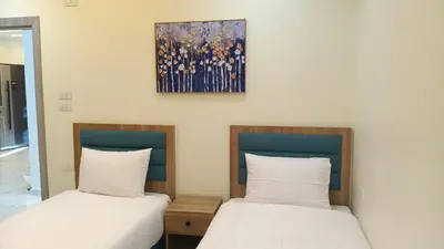 two beds sitting next to each other in a room at 4S Icon Suites in Hurghada
