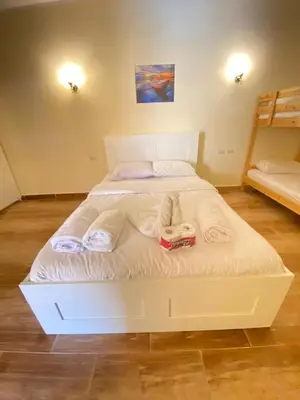 a bedroom with a white bed with towels on it at florenza Resort - Hurghada Egypt in Hurghada