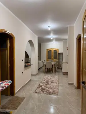a living room with a table and a dining room at Pharaohs Apartments - Panoramic Fourth Floor Apartment in Luxor