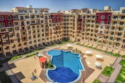 an aerial view of a large apartment complex with a swimming pool at Ezz in Hurghada