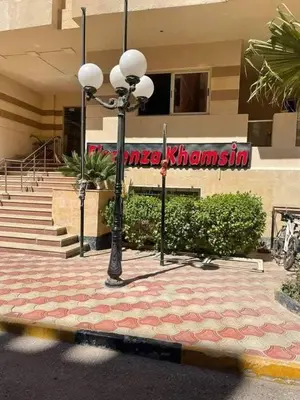 a street light in front of a building at Ezz in Hurghada