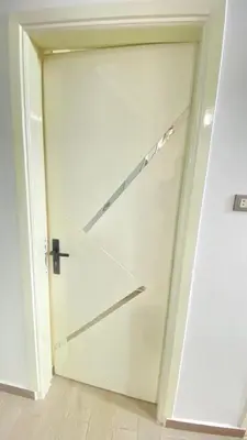 a large white garage door with a metal handle at FUN MBASSY DELUXE APARTMENT ASWAN down town in Aswan
