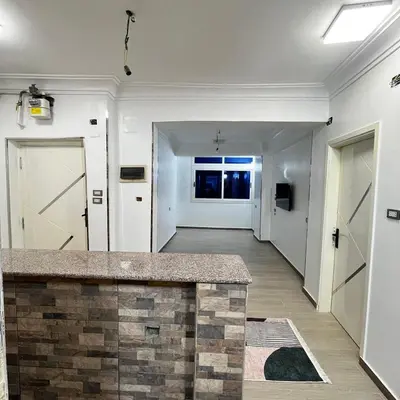 a room with a hallway with doors and a counter at FUN MBASSY DELUXE APARTMENT ASWAN down town in Aswan