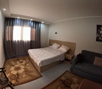 a small bedroom with a bed and a couch at Sea La Vie Furnteched, Central, Beach Front, Free WIFI in Hurghada