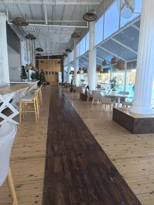 a large room with tables and chairs and windows at Selena Bay in Hurghada