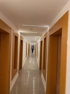 a hallway in a building with a person walking down it at CBA - Cavalli Boutique Apartments in Hurghada