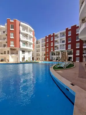 a swimming pool in front of some apartment buildings at Aqua Palms Resort Hurghada in Hurghada