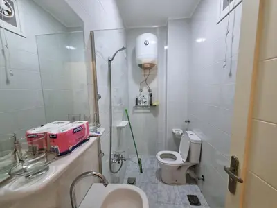 a small bathroom with a toilet and a sink at Aqua Palms Resort Hurghada in Hurghada