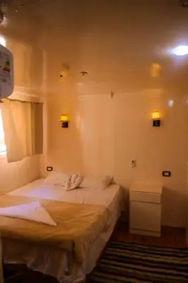 a bedroom with two beds and a window at Water Lily in Luxor