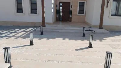 a group of poles on a sidewalk in front of a building at Stunning Villa with breathtaking golf & lake view in Hurghada