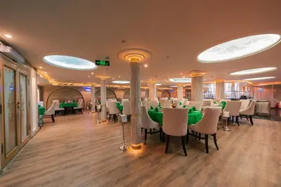 a restaurant with tables and chairs in a room at فندق نايل ستوري سوهاج in Suwhaj