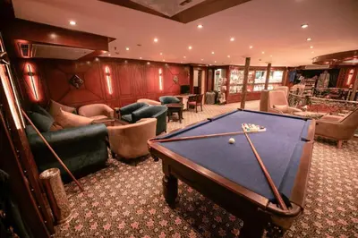 a room with a pool table in a living room at فندق نايل ستوري سوهاج in Suwhaj