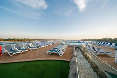 a row of chaise lounge chairs on a cruise ship at فندق نايل ستوري سوهاج in Suwhaj
