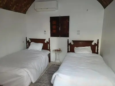 two beds sitting next to each other in a bedroom at Soul house in Aswan