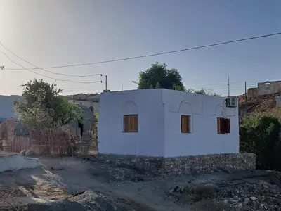 a small white house on top of a dirt road at Soul house in Aswan