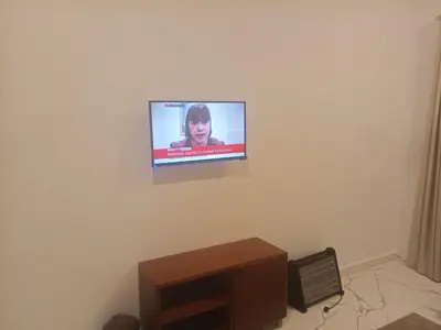 a flat screen tv on a wall in a room at Habu Palace home in Luxor