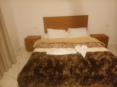 a bedroom with a bed with a blanket and a heart on it at Habu Palace home in Luxor