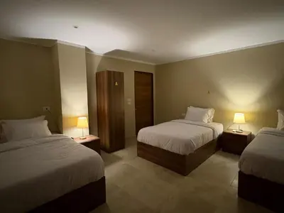 a hotel room with two beds and two lamps at The Fit Stop Hostel in Hurghada