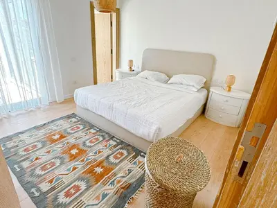 a bedroom with a bed and a chair and a rug at Amazing 4 BR Villa in Soma Bay Movin Stay in Hurghada