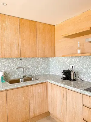 a kitchen with wooden cabinets and a sink at Amazing 4 BR Villa in Soma Bay Movin Stay in Hurghada