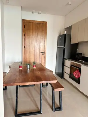 a kitchen with a wooden table with two plants on it at EL GOUNA Boho Beach Chalet with pool access in Hurghada