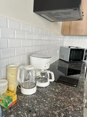 a kitchen counter with a mixer and a coffee maker at 2BR Ground Floor Apartment with Heated Pool in Bali El Gouna in Hurghada