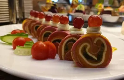 a white plate of food with tomatoes and vegetables at فندق نايل ايليت سوهاج in Qilfāw