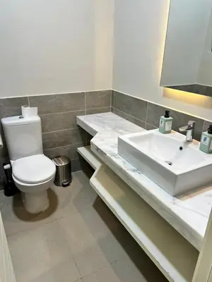 a bathroom with a toilet and a sink at Cyan Lakefront 3BR Townhouse El Gouna in Hurghada