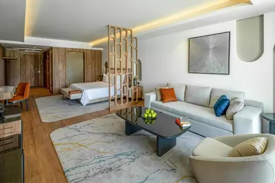 a living room with a couch and a table at Rixos Premium Magawish Bay View in Hurghada