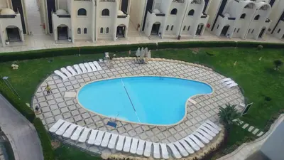 an overhead view of a swimming pool in front of a building at Sea View Apartment Inside Gravity Hotel in Hasheesh Plain in Hurghada