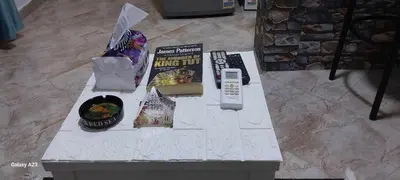 a table with a book and a remote control on it at Sea Breeze in Hurghada